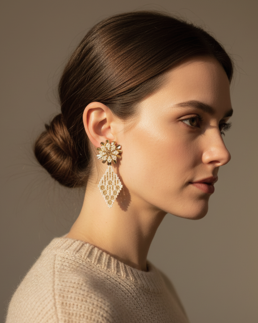 Profile view of model wearing ivory-and-gold Miyuki flower stud with diamond drop earrings, 24k gold-plated bronze base.