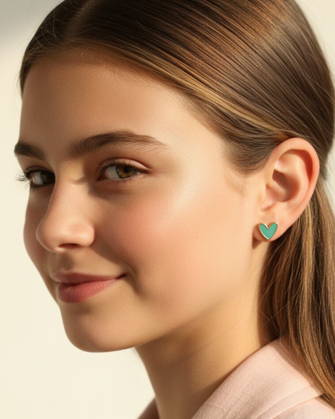 Mint resin heart stud with gold rim on model wearing a denim jacket.