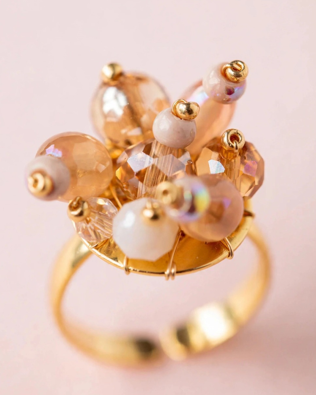 Close-up of Nude Bouquet adjustable gold-plated ring featuring a cluster of blush pink, champagne, and ivory Murano and glass beads.