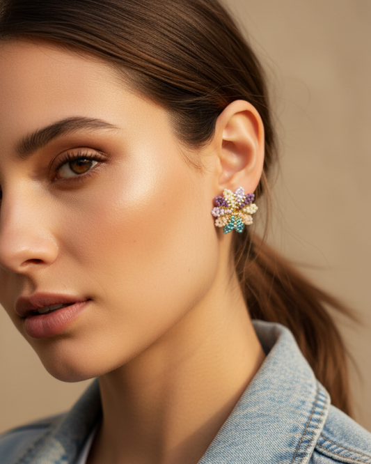 Pastel lilac Miyuki flower stud with gold center on model’s earlobe.